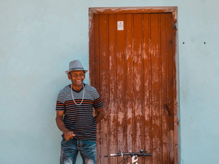 Man In Hat Standing Near Door