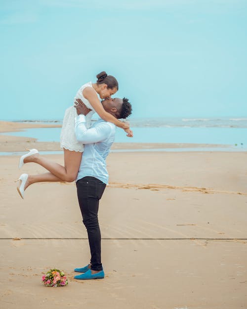 Man Kissing a Woman at the Beach