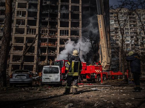 Free Firefighters tackle a blaze in a damaged building in Kyiv, Ukraine. Stock Photo