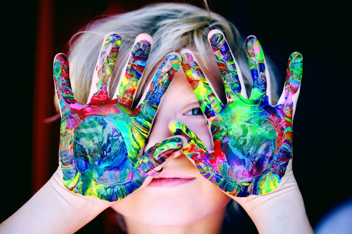 Child With Multicolored Hand Paint