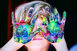 A KId With Multicolored Hand Paint