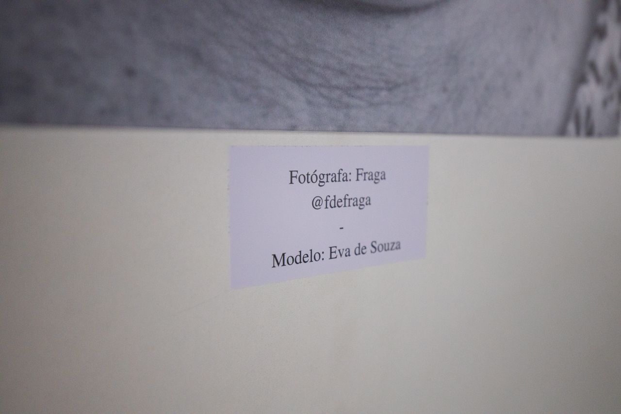 label detailing photographer and model under a framed photograph