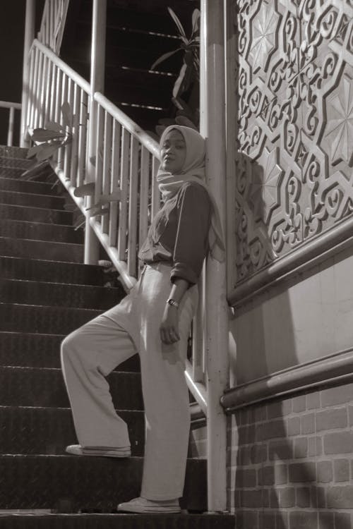 Woman in White Hijab Standing on Staircase