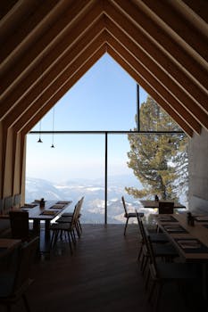 Chic restaurant with panoramic mountain views in Obereggen, Italy.