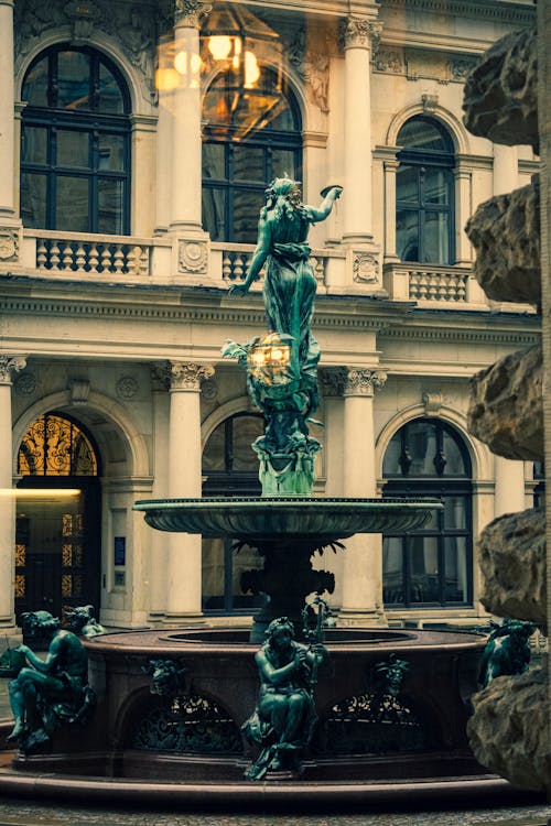 Gray Concrete Statue on the Water Fountain