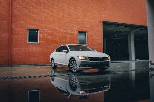 A Car Parked Beside Brown Brick Building