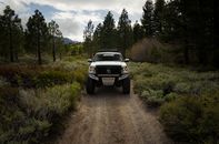 Photo of White Pickup Truck Running on Dirt Pathway