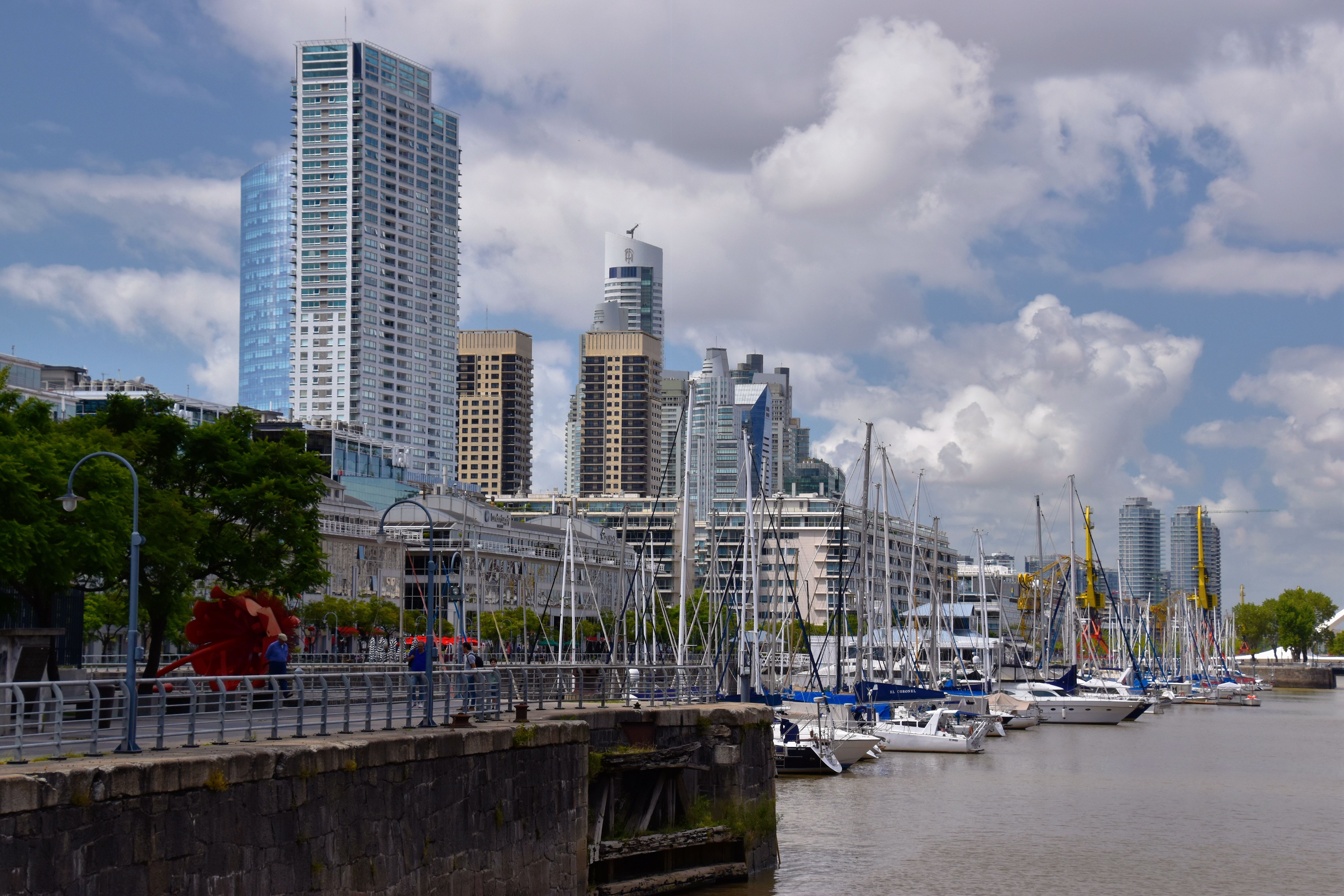 Skyscrapers and docked sailboats in Puerto Madero, Buenos Aires on a sunny day.