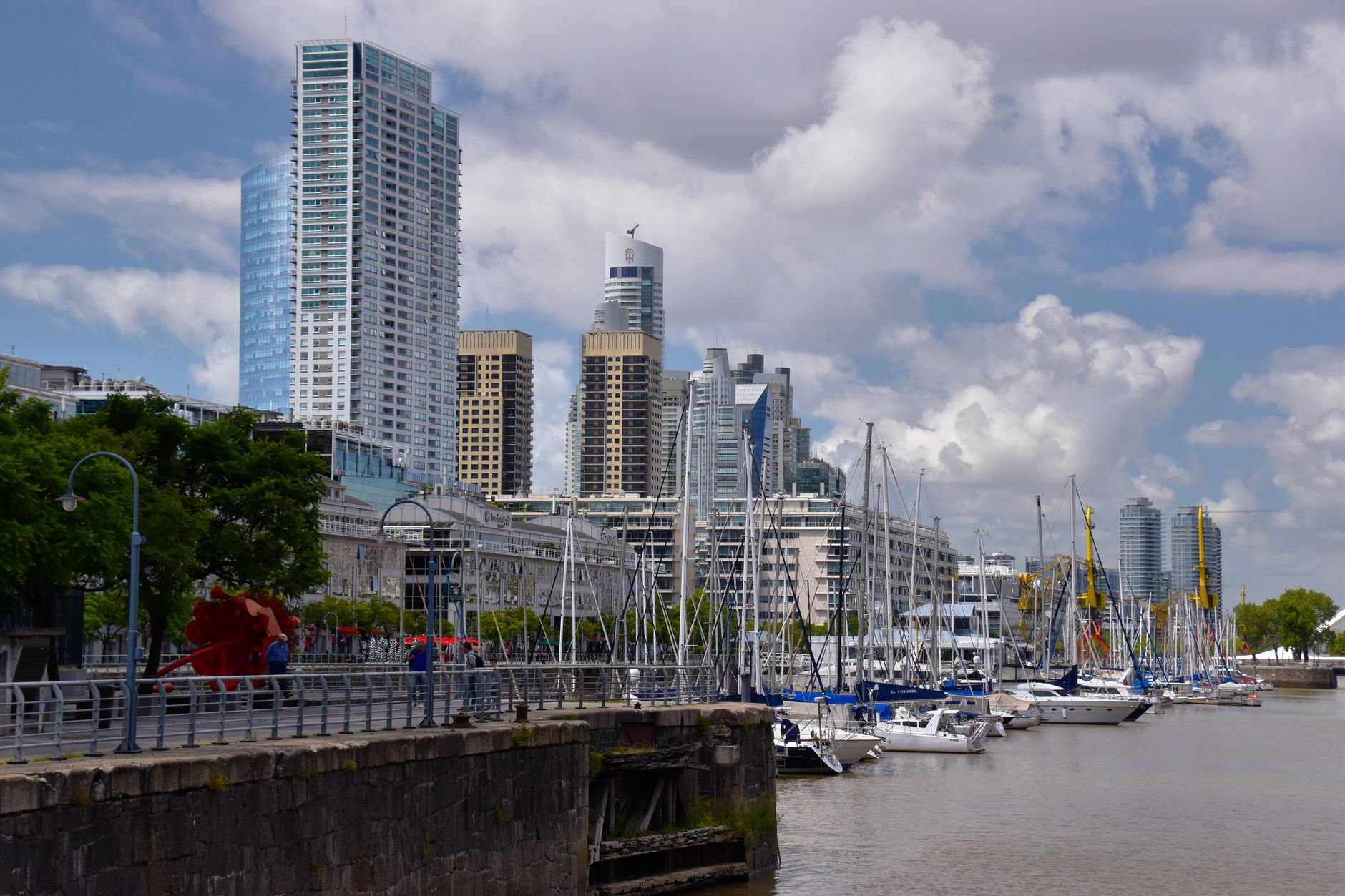 Skyscrapers and docked sailboats in Puerto Madero, Buenos Aires on a sunny day.