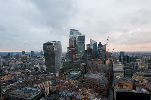 Free Stunning aerial view of London's modern skyscrapers and iconic architecture at dusk. Stock Photo