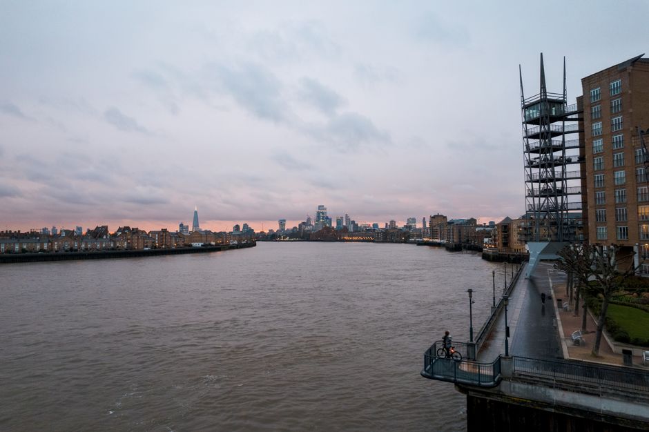 A stunning view of the Thames River and London's skyline featuring modern architecture at twilight.