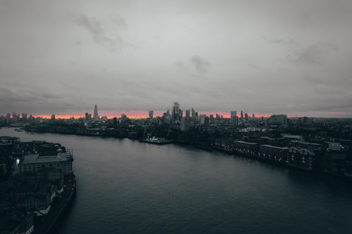 Free Aerial view of London's skyline at twilight with high-rise buildings along the river. Stock Photo