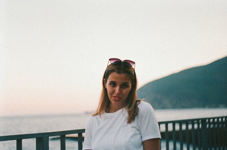 Woman Sticking Her Tongue Out On Pier