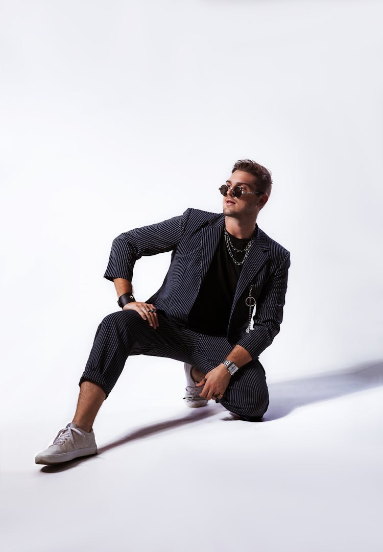 Man In Sunglasses And Suit Kneeling