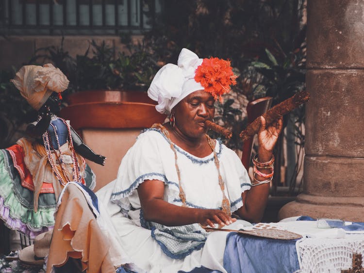 Black Woman In Festive Costume Smoking Cigar