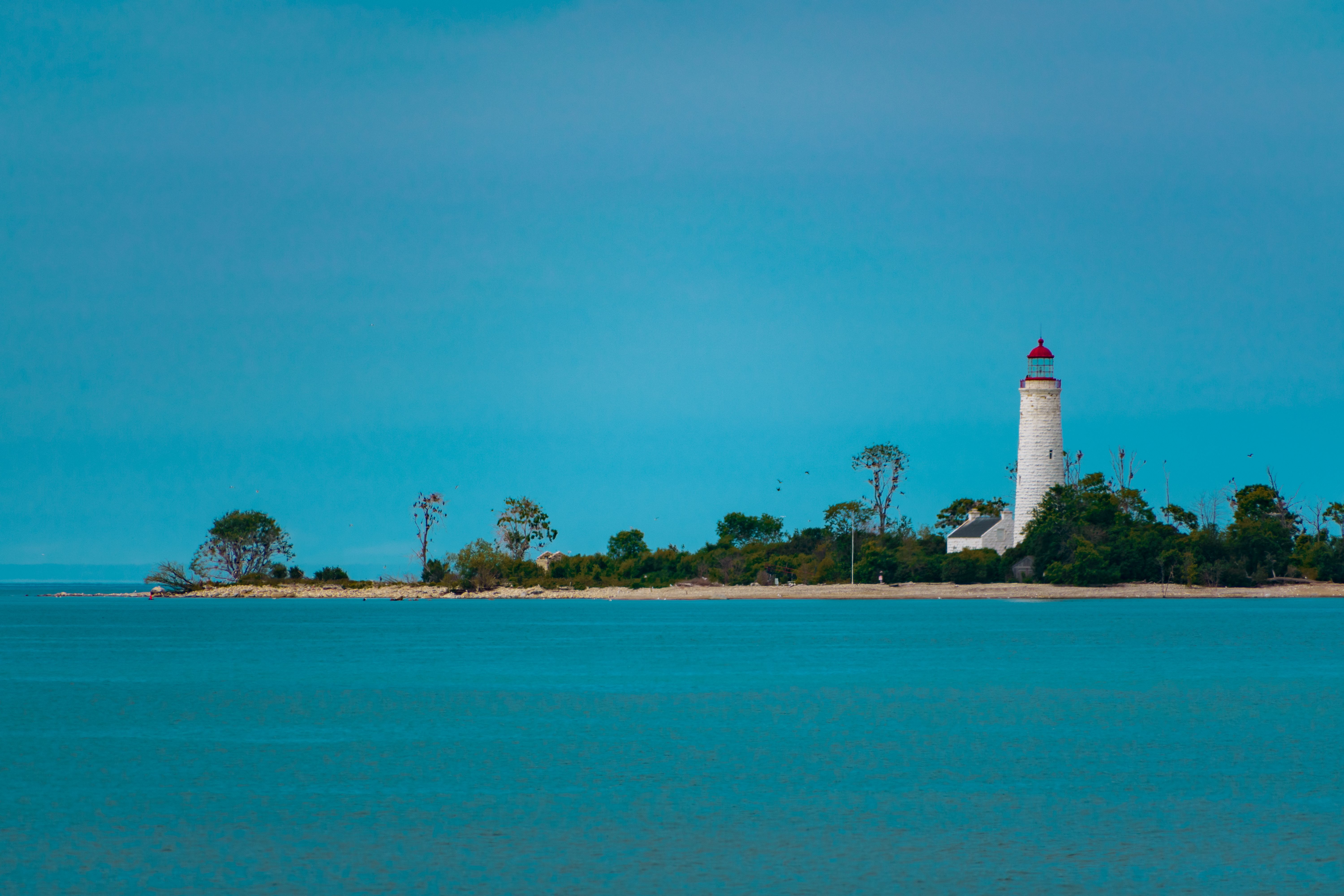 Beautiful view of a lighthouse on a serene coastline in Tobermory, Ontario.