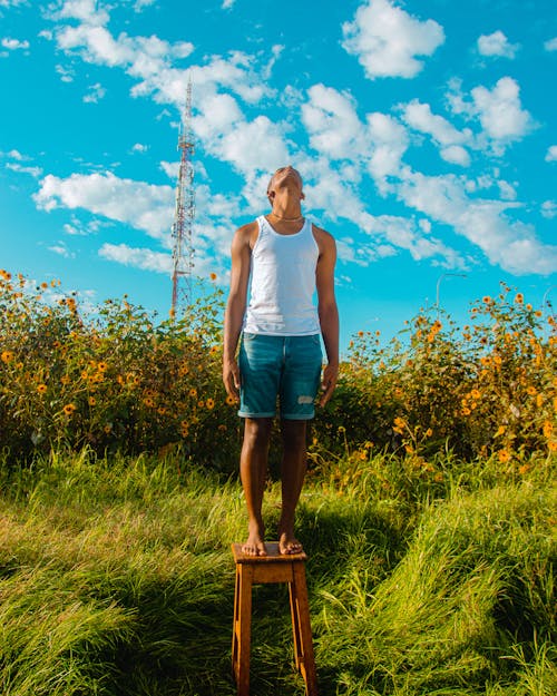 A Man Standing on a Grassy Field