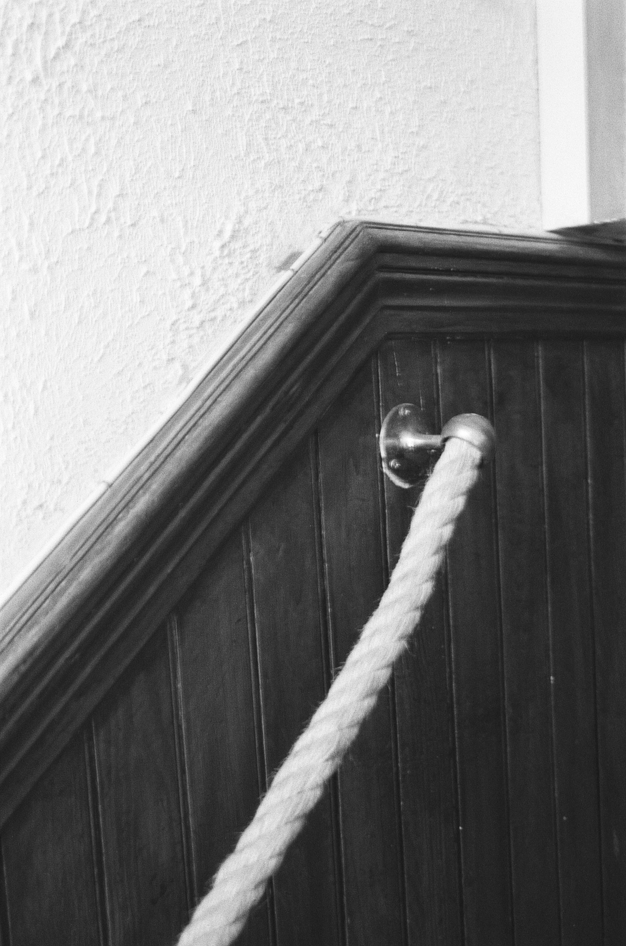 Monochrome Photo of a Rope Near Wooden Panels · Free Stock Photo