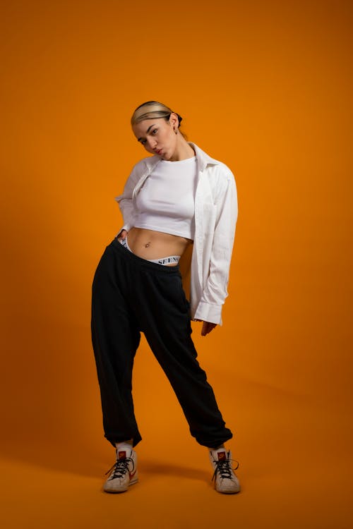 Woman in a White Crop Top Posing with Her Hand on Her Waist