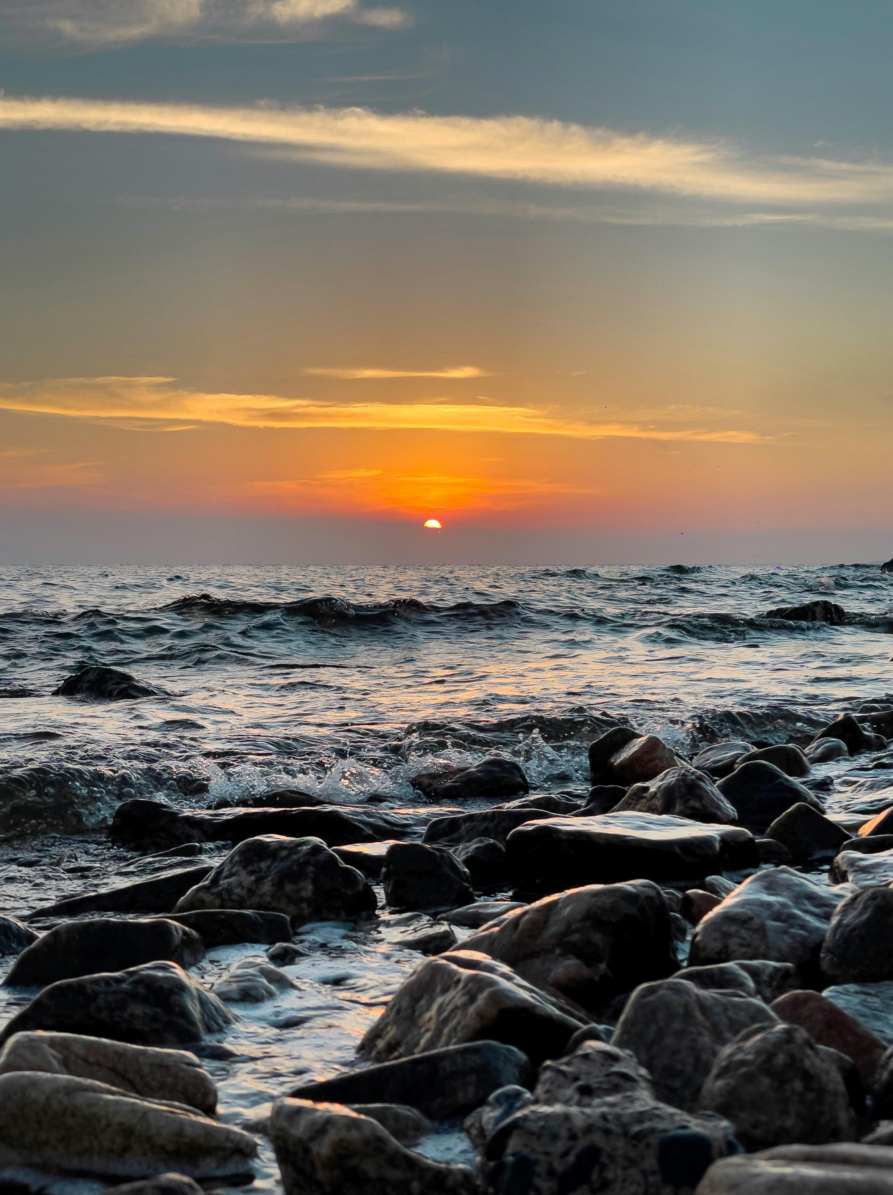 Photo of Stones and Waves During Golden Hour · Free Stock Photo