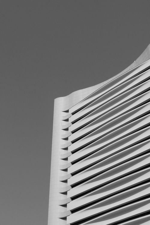 Free Black and white photo of a modern skyscraper with a unique façade in Hong Kong. Stock Photo