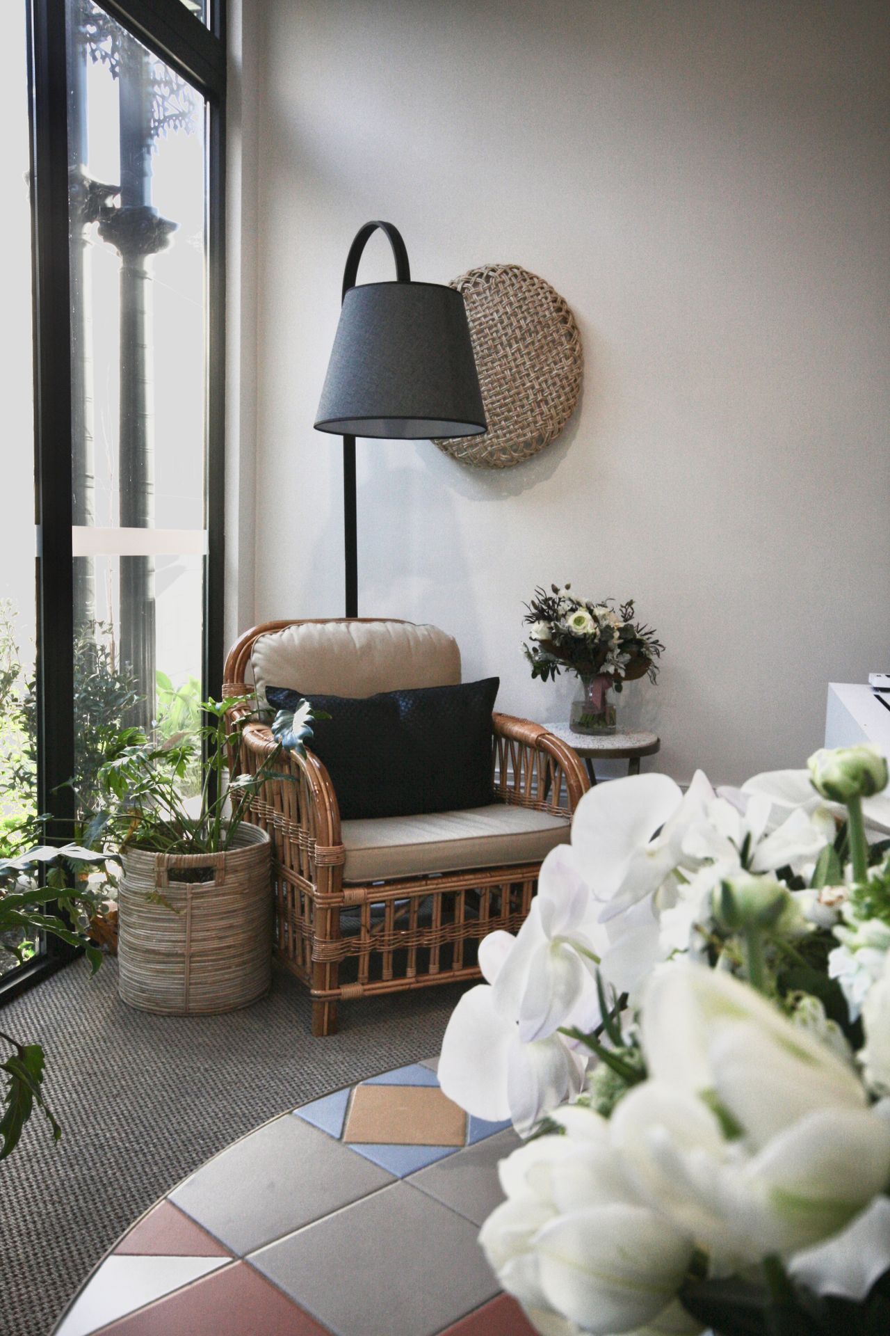 Wicker armchair reading nook by a bright window