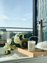 White Roses in Clear Glass Vase on Brown Wooden Table