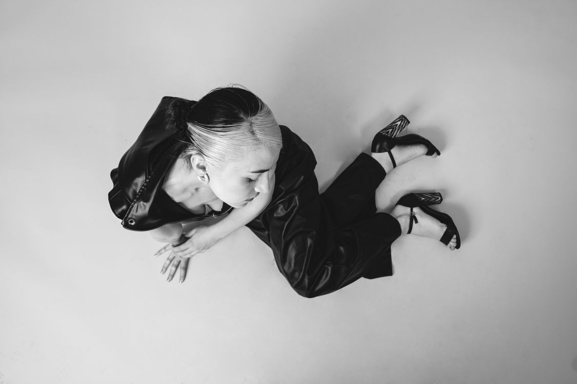 Woman in Black Leather Outfit Sitting on The Floor · Free Stock Photo