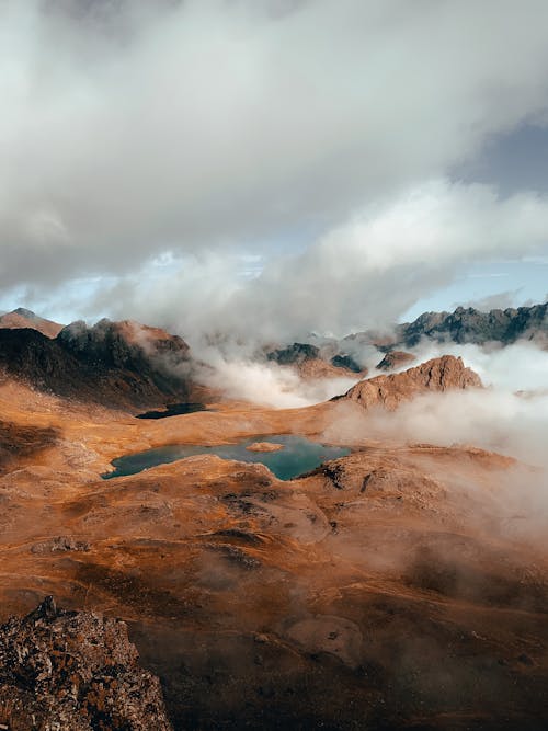 Clouds over Mountains and Crater Lake in Landscape