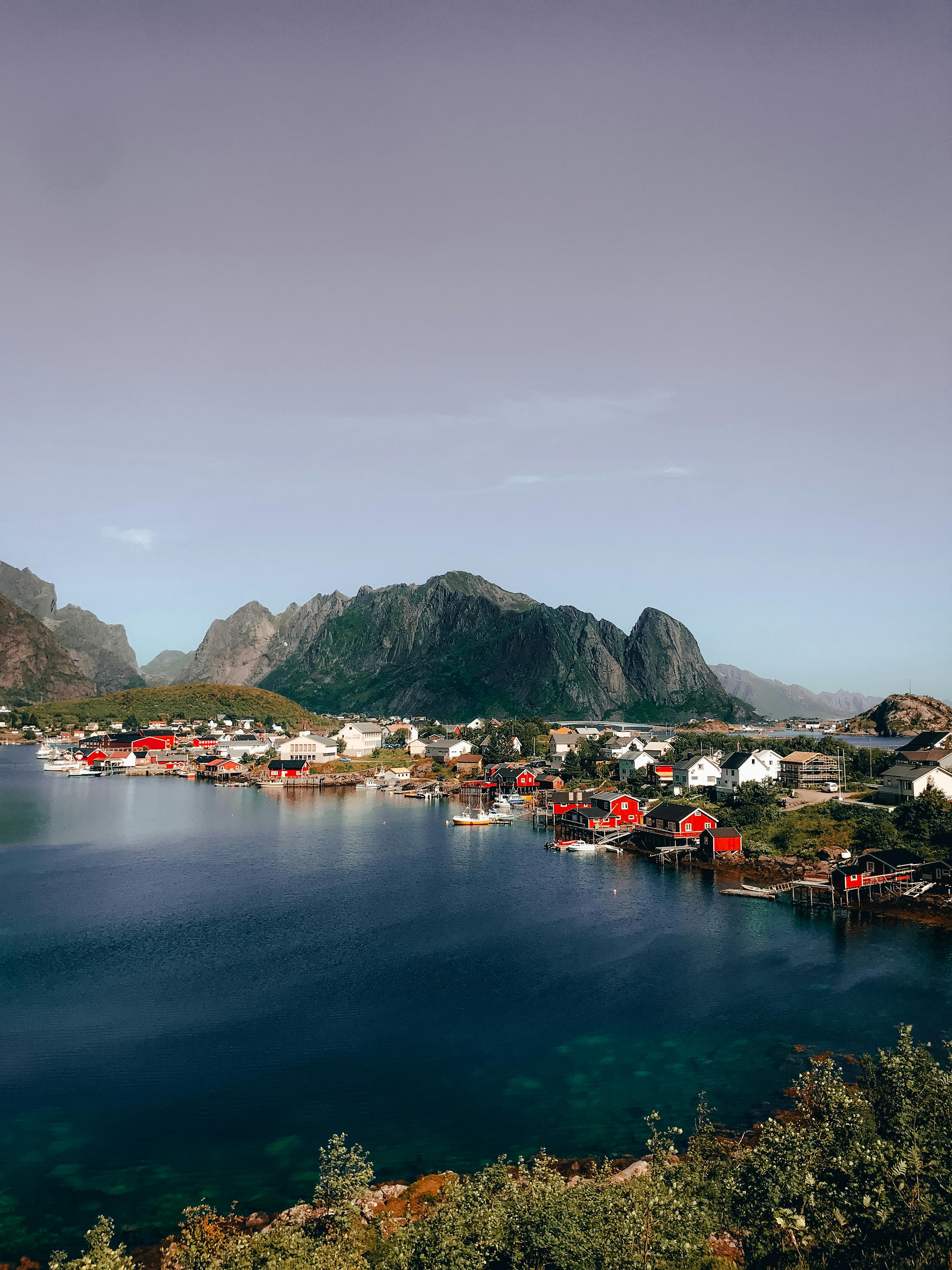 Stunning view of Reine, a picturesque fishing village in Lofoten, Norway, surrounded by mountains and serene waters.