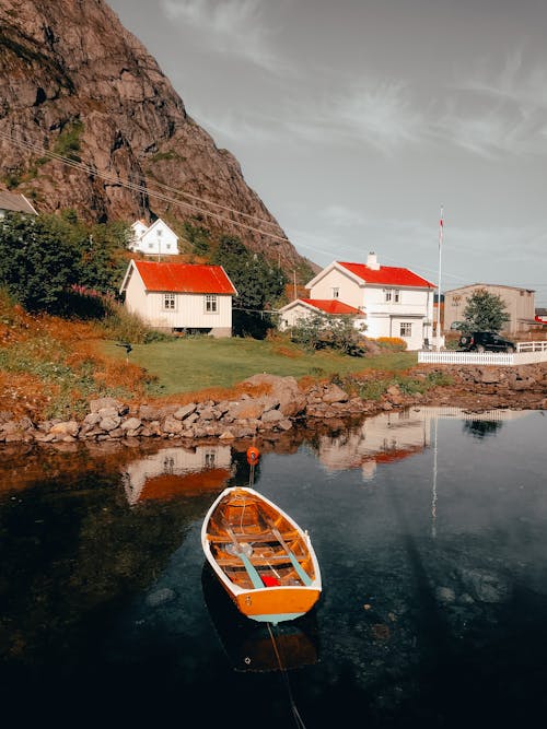 Brown Wooden Boat on Body of Water