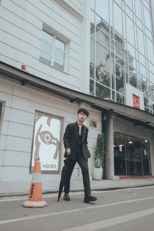 Man in Black Suit Standing Near Building