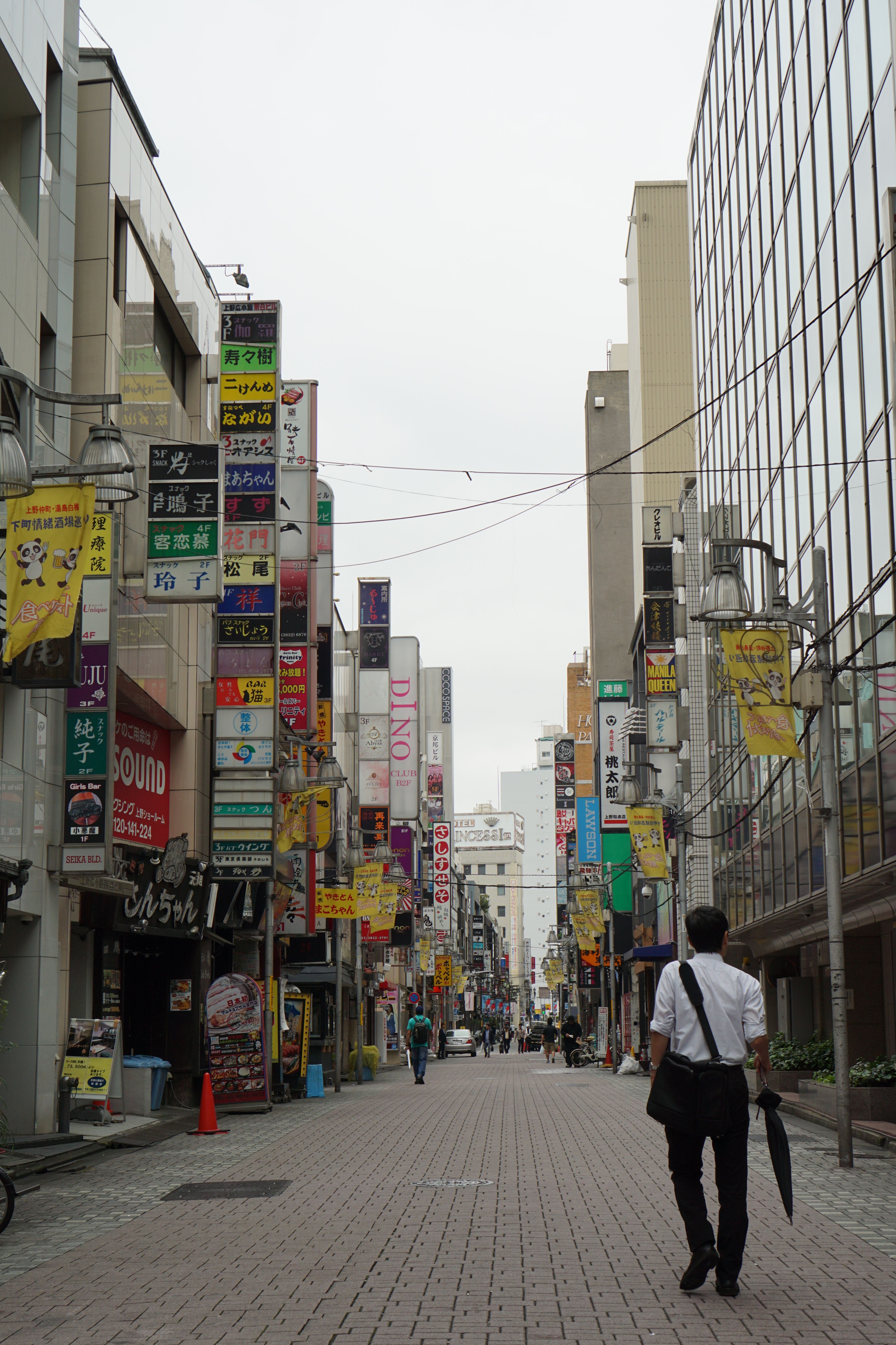Back View of a Man Walking on City Street · Free Stock Photo
