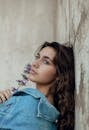 Pretty Girl in Denim Blue Jacket Leaning Against Wall