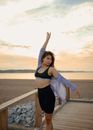 Girl Posing on Wooden Platform in Beach 