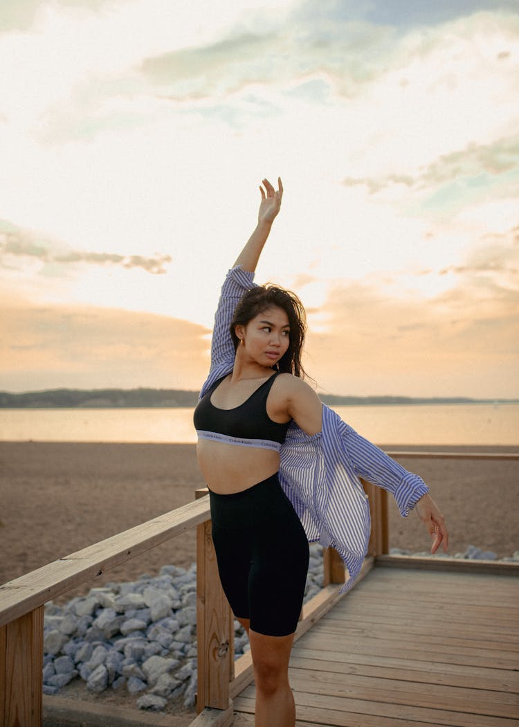 Girl Posing On Wooden Platform In Beach 