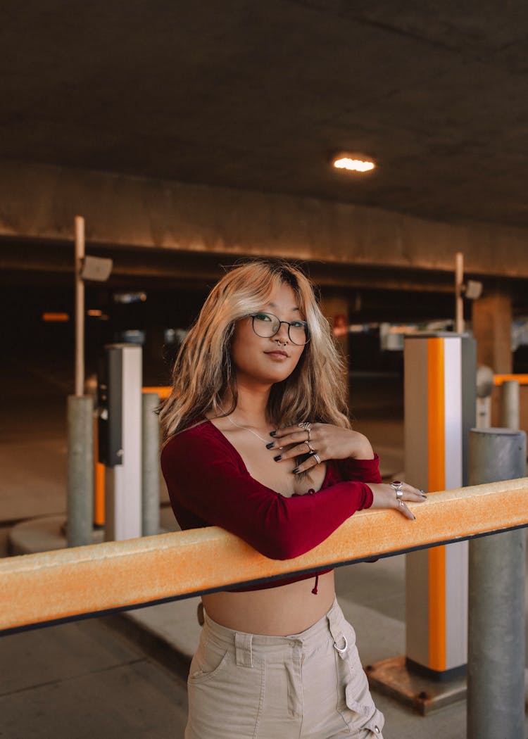 Smiling Woman With Long Blond Dyed Hair In Underground Car Park