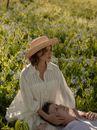 Woman in Straw Hat and Her Partner with Head on Her Lap