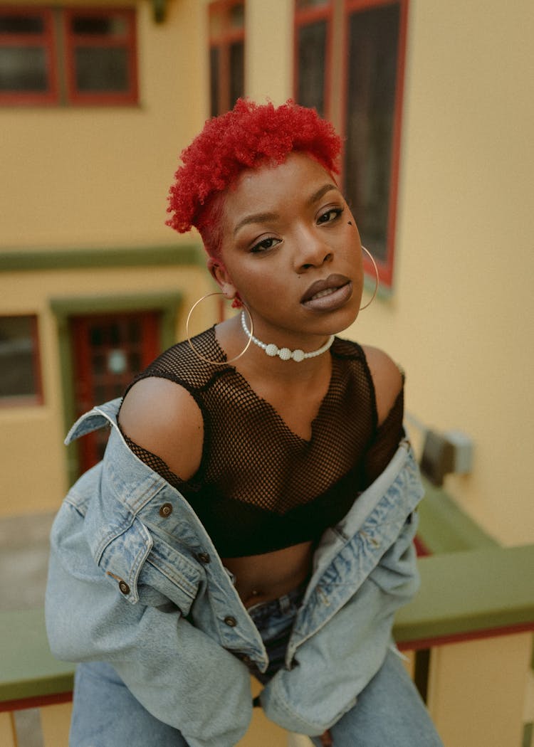 Redhead Woman With African Hairstyle In Denim Jacket