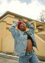 Redhead Woman in Denim Jacket and Jeans Walking with Raised Arms