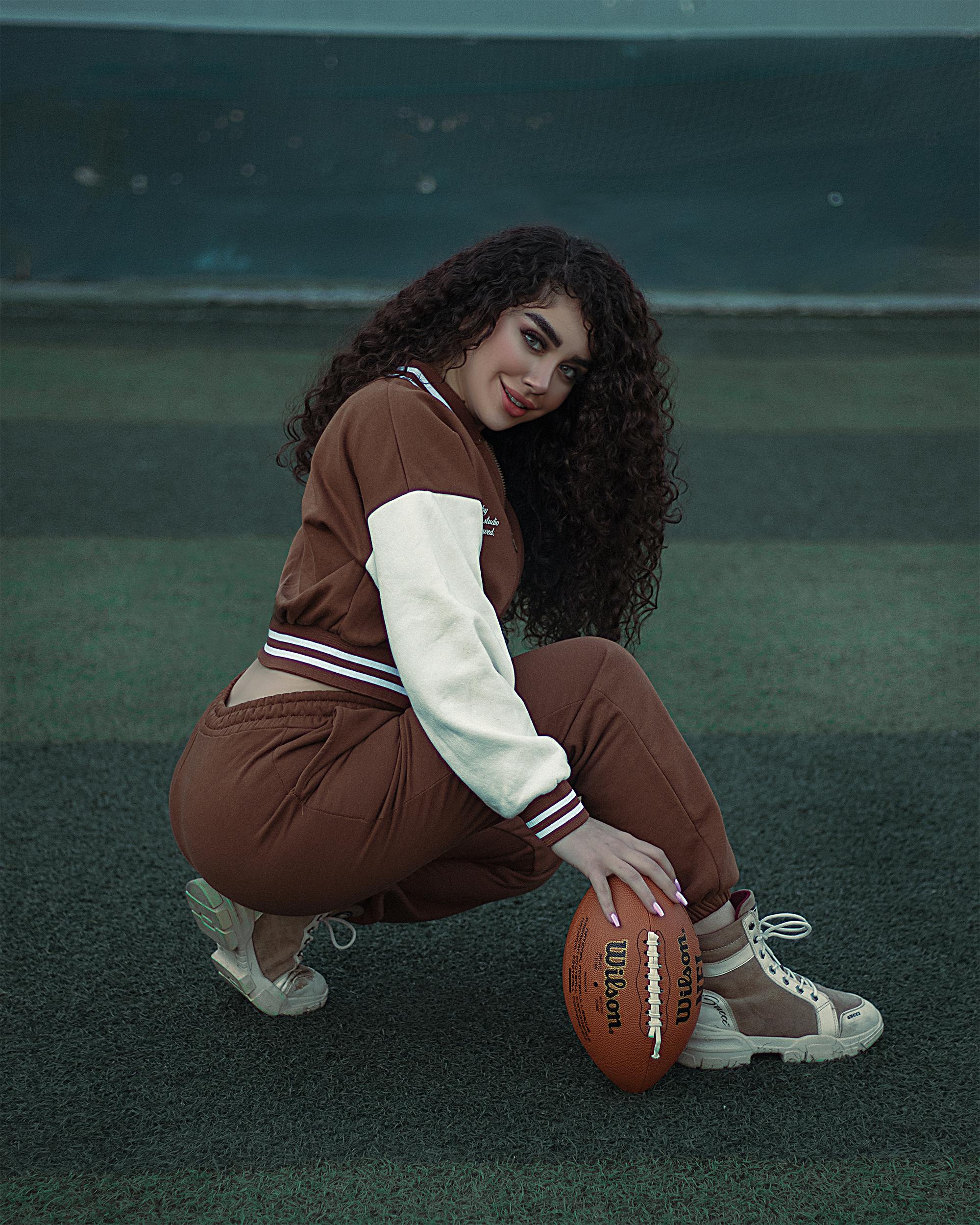 a woman holding a football