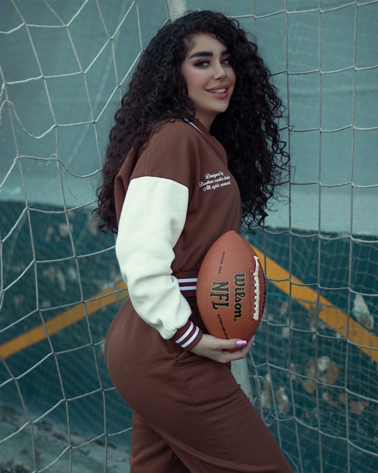 Beautiful Woman Holding A Football