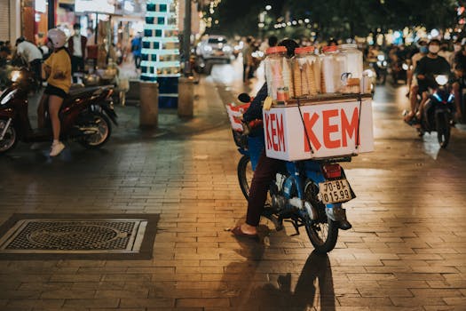 A vibrant scene of a street vendor selling ice cream at night in Ho Chi Minh City, Vietnam.