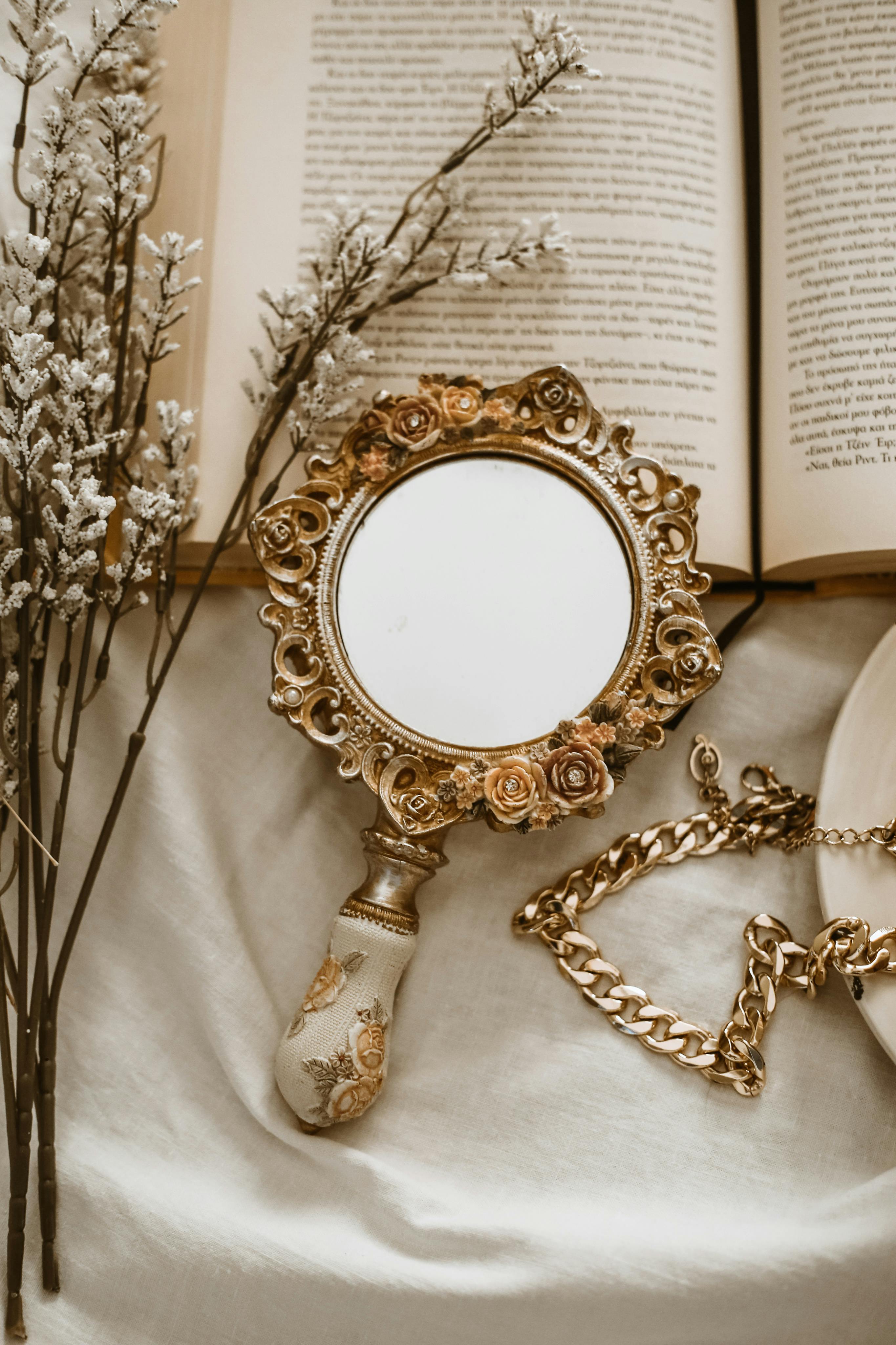 mirror lying on open book