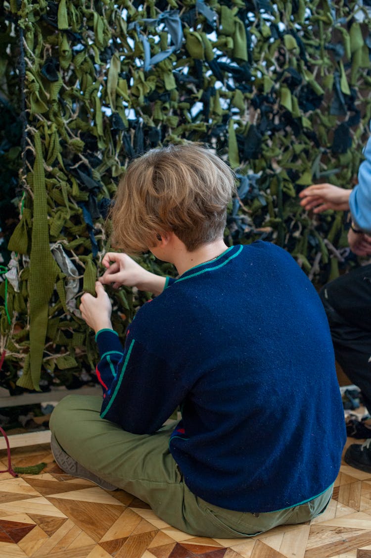 Back View Of Girl Weaving Military Masking Webs