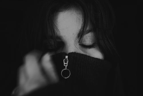 Woman Covering Face with Sweater