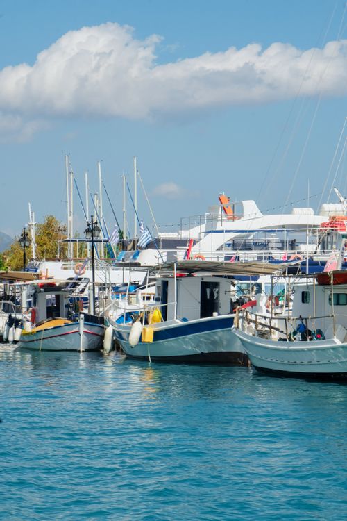 Free Vibrant marina scene with docked sailboats and yachts under a clear sky. Stock Photo