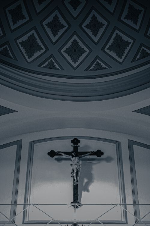 Free Captivating architectural details of a church ceiling with a central crucifix. Stock Photo