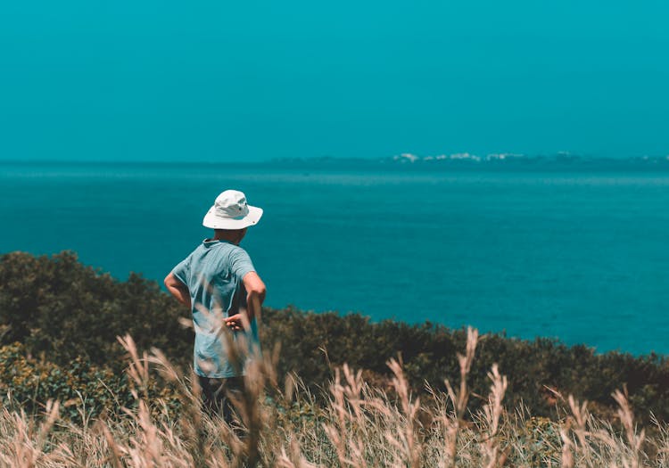 A Man Wearing Bucket Hat While Sightseeing