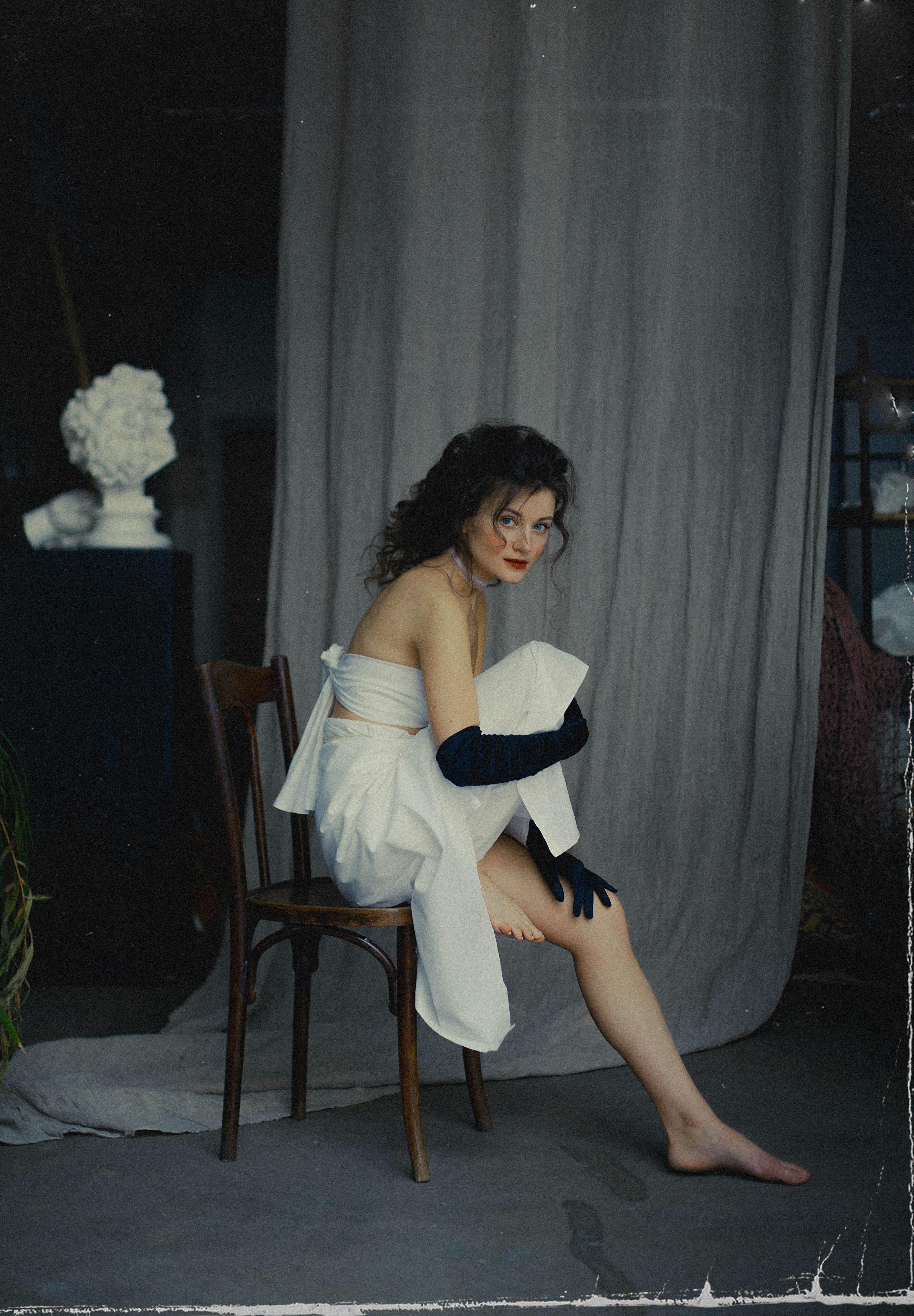 old photograph of woman sitting on chair